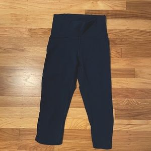 Navy Blue Lululemon leggings, cropped with mesh side strip.